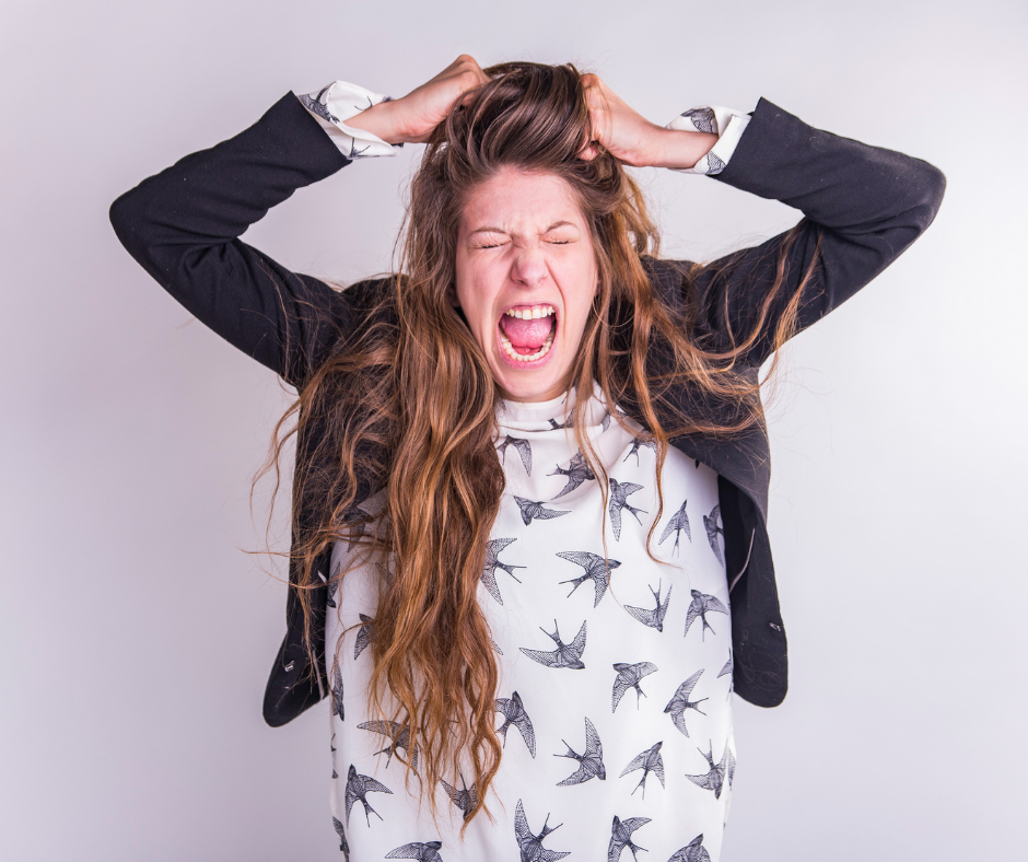 A white lady, is pulling her hair in frustration